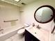 Bright bathroom with an oval mirror, ample lighting, and marble counter at 5603 Sycamore N St # 5603, St Petersburg, FL 33703