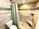 Beautiful bathroom with mosaic tile accents, safety handles, and a built-in shower seat at 5603 Sycamore N St # 5603, St Petersburg, FL 33703
