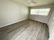 Serene bedroom with wood-look floors, natural light, and a closet at 5603 Sycamore N St # 5603, St Petersburg, FL 33703