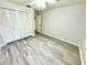 A clean bedroom with wood-look floors, closet and ceiling fan at 5603 Sycamore N St # 5603, St Petersburg, FL 33703