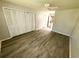 Cozy bedroom with wood-look floors, ceiling fan and closet at 5603 Sycamore N St # 5603, St Petersburg, FL 33703