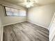 This cozy bedroom features wood-look flooring, a ceiling fan, and great natural light at 5603 Sycamore N St # 5603, St Petersburg, FL 33703