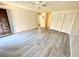Bright and airy living room with wood-look floors, ceiling fan, and closet at 5603 Sycamore N St # 5603, St Petersburg, FL 33703