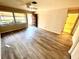 Open living room with wood-look floors, large window and entry door at 5603 Sycamore N St # 5603, St Petersburg, FL 33703