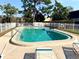 Sunny community pool area with lounge chairs and a secure white fence at 5603 Sycamore N St # 5603, St Petersburg, FL 33703