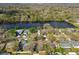 Scenic aerial shot capturing homes adjacent to a tranquil lake surrounded by lush trees at 5822 Silver Moon Ave, Tampa, FL 33625