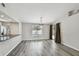 Open-concept living and dining area featuring luxury vinyl plank flooring and modern lighting at 5822 Silver Moon Ave, Tampa, FL 33625