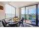 Dining area with golf course and water views from the large glass doors at 6210 Sun Blvd # 408, St Petersburg, FL 33715