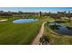 Scenic golf course featuring green grass, ponds, and palm trees at 6210 Sun Blvd # 408, St Petersburg, FL 33715