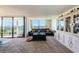 Spacious living room with sliding doors to lanai, and built-in display cabinet at 6210 Sun Blvd # 408, St Petersburg, FL 33715