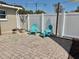 Inviting backyard with brick pavers, a white fence, and comfortable seating, perfect for outdoor enjoyment at 6310 57Th N Ave, St Petersburg, FL 33709