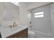 Bathroom with vanity, granite countertop, modern fixtures, tile floor, bathtub, and a window above tub at 6310 57Th N Ave, St Petersburg, FL 33709