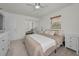 Neutral bedroom with a ceiling fan, closet with mirrored sliding doors, and a large window with wood blinds at 6310 57Th N Ave, St Petersburg, FL 33709