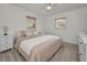 Comfortable bedroom with carpet flooring, a queen-sized bed, and white nightstands at 6310 57Th N Ave, St Petersburg, FL 33709