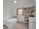 Cozy bedroom with white walls, carpet, a built-in bookshelf, and a window at 6310 57Th N Ave, St Petersburg, FL 33709