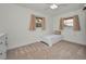White walled bedroom with carpet, two windows, and a dresser at 6310 57Th N Ave, St Petersburg, FL 33709
