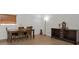 Cozy dining room featuring hardwood floors, a wooden table with chairs, and a buffet at 6310 57Th N Ave, St Petersburg, FL 33709