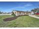 Well-kept house with green lawns, a garden bed, and a white fence for added curb appeal and privacy at 6310 57Th N Ave, St Petersburg, FL 33709