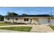 Charming single story home with white brick and a well-maintained lawn and front garden at 6310 57Th N Ave, St Petersburg, FL 33709