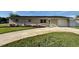 Traditional home with well-manicured landscaping, long driveway, and single-car garage at 6310 57Th N Ave, St Petersburg, FL 33709