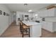 Bright, updated kitchen features an island with seating, stainless steel appliances, and sleek white cabinets at 6310 57Th N Ave, St Petersburg, FL 33709