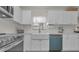 Modern farmhouse kitchen with white cabinets, stainless steel appliances, and a large farmhouse sink at 6310 57Th N Ave, St Petersburg, FL 33709