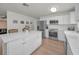 Spacious kitchen with white cabinets, stainless steel appliances, and a large center island at 6310 57Th N Ave, St Petersburg, FL 33709