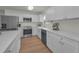 Modern kitchen featuring white cabinets, stainless steel appliances, and a farmhouse sink at 6310 57Th N Ave, St Petersburg, FL 33709