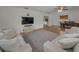 Open-concept living area with wood floors, offering a comfortable seating area and a dining space with a table at 6310 57Th N Ave, St Petersburg, FL 33709