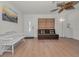Bright living room featuring a white bench, sleeper sofa, and modern ceiling fan at 6310 57Th N Ave, St Petersburg, FL 33709