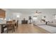 Open-concept living room with wood floors and comfortable seating connected to the dining space at 6310 57Th N Ave, St Petersburg, FL 33709