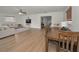 Open living space with a dining area, hardwood floors, and a modern entertainment center at 6310 57Th N Ave, St Petersburg, FL 33709