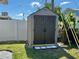 Close up on backyard shed set amongst greenery. White fence in the background at 6310 57Th N Ave, St Petersburg, FL 33709