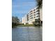 View of the condo building from the lake with balconies and landscaped grounds at 6425 Shoreline Dr # 10506, St Petersburg, FL 33708