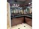 Modern bathroom featuring a unique vanity, black countertops, and mirrored walls with recessed lighting at 6425 Shoreline Dr # 10506, St Petersburg, FL 33708