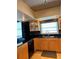Modern kitchen with stainless steel appliances, granite countertops, and wood cabinets at 6425 Shoreline Dr # 10506, St Petersburg, FL 33708