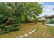 Backyard with stone pathway and mature trees at 7327 Egypt Lake Dr, Tampa, FL 33614