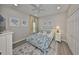 Bright bedroom featuring neutral tones, beach themed art, and ceiling fan at 827 Seminole Sky Dr, Ruskin, FL 33570