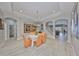 Elegant dining room with tray ceilings, and an open floor plan leading to the staircase and living area at 827 Seminole Sky Dr, Ruskin, FL 33570