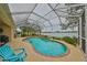 Enclosed pool area featuring a kidney-shaped pool with a waterfall feature and views of the lake at 827 Seminole Sky Dr, Ruskin, FL 33570