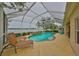 Screened-in backyard pool area, lake view, and outdoor seating at 827 Seminole Sky Dr, Ruskin, FL 33570