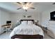 Cozy bedroom featuring a king-sized bed, desk area, and soft, neutral color palette at 8658 Parsons Hill Blvd, Wesley Chapel, FL 33545