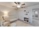 Bright Bedroom featuring a white crib, comfortable armchair, decorative shelves, and a modern ceiling fan at 8658 Parsons Hill Blvd, Wesley Chapel, FL 33545