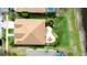 An aerial view showcases a home's backyard, with its paver patio and landscaping, from above at 9511 Laurel Ledge Dr, Riverview, FL 33569