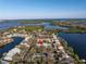 Scenic aerial view of a waterfront community with lush greenery, a body of water, and residential homes at 992 San Carlos Ne Ct, St Petersburg, FL 33702