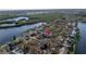 Scenic aerial view of a waterfront community with lush greenery, a body of water, and residential homes at 992 San Carlos Ne Ct, St Petersburg, FL 33702