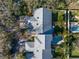 Aerial view of the property showcasing the roof, driveway, and surrounding greenery at 992 San Carlos Ne Ct, St Petersburg, FL 33702