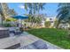 Spacious backyard with green lawn, tropical landscaping, and a white fence at 992 San Carlos Ne Ct, St Petersburg, FL 33702