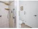 Bathroom featuring a walk-in shower with tile surround and accessible grab bars at 992 San Carlos Ne Ct, St Petersburg, FL 33702
