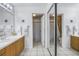 Bathroom with double vanity sinks, large mirrors, and a separate toilet and shower area at 992 San Carlos Ne Ct, St Petersburg, FL 33702